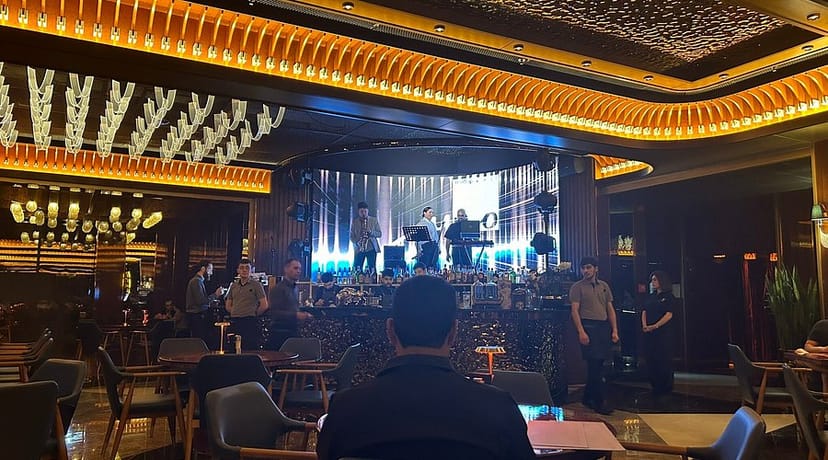 Corporate event in Juno Restaurant lounge with digital backdrop and live entertainment.