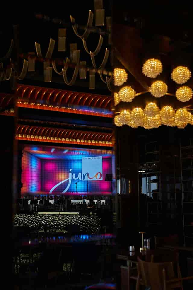 Juno Restaurant common area with stage lighting and screen for corporate events and product launches.