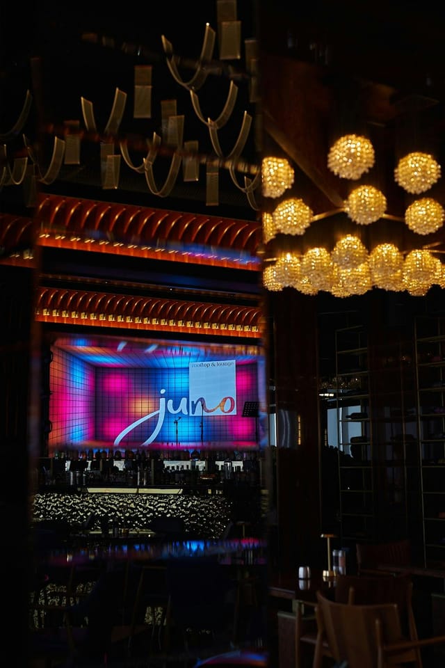 Juno Restaurant common area with stage lighting and screen for corporate events and product launches.