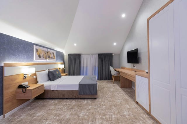 Modern hotel guest room in Baku with dedicated workspace for business travel.