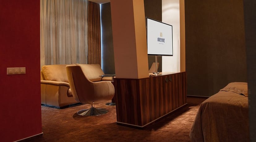 Avenue Hotel executive suite with lounge and A/V for high-end breakout meetings and consultations.