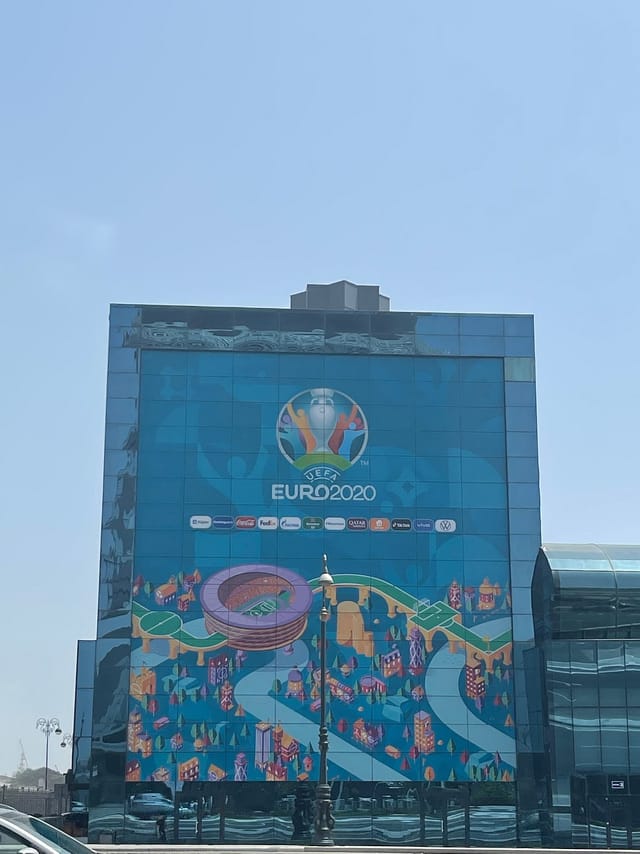 Large-format building branding at Avenue Hotel for international event sponsorship.