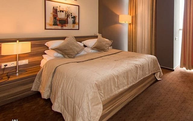 Upscale Avenue Hotel guest room for corporate travel and conference accommodation.