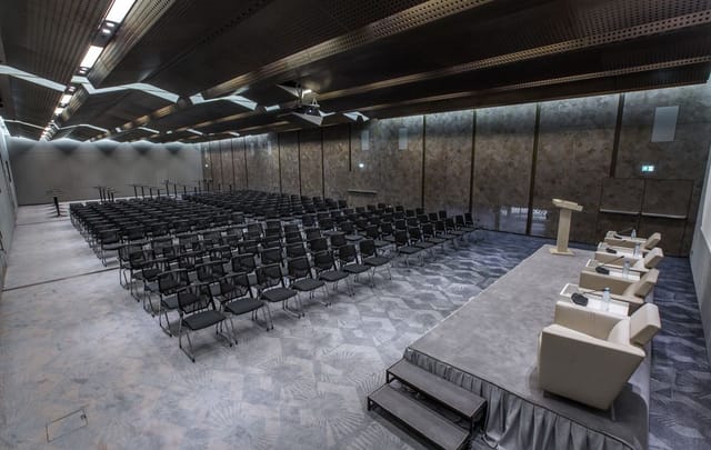 Congress Hotel conference room with theater-style stage for professional corporate events.