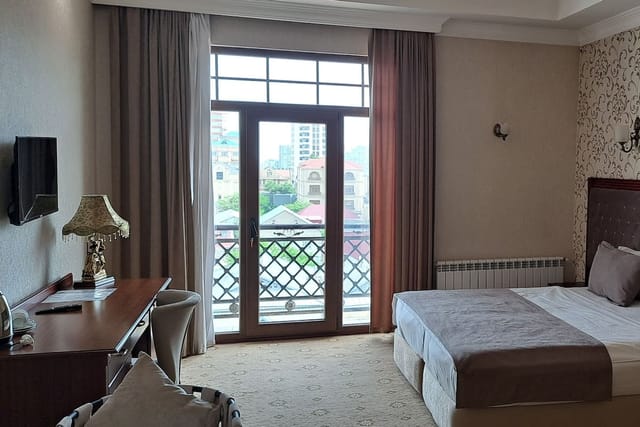 Capitol Hotel suite with dedicated workstation for corporate travel and conference accommodation.