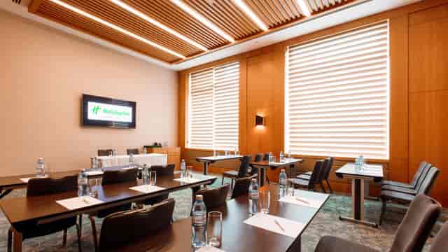 Boardroom at Holiday Inn Baku with AV setup for corporate training and workshop meetings.