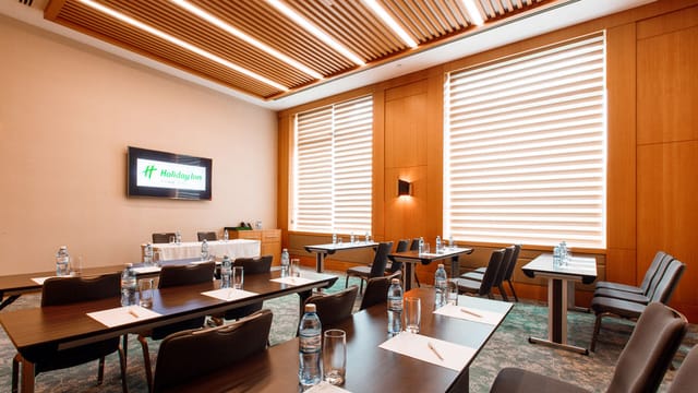 Boardroom at Holiday Inn Baku with AV setup for corporate training and workshop meetings.