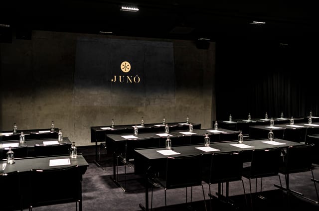Sleek dark classroom setup at Juno Hotel for executive corporate board meetings.