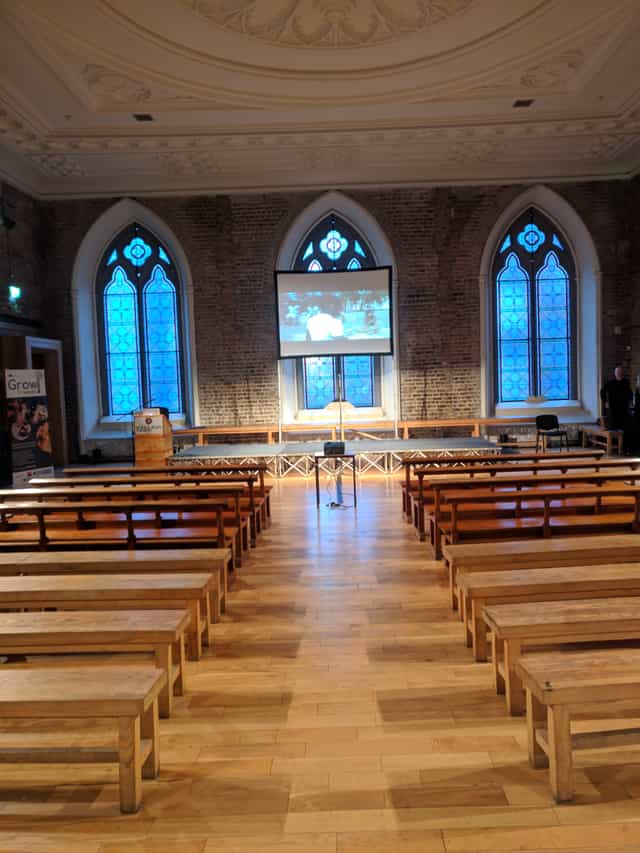 Historic Smock Alley Theatre banquet hall with bench seating for corporate events and presentations.