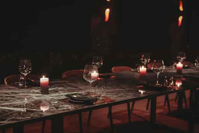 Elegant monochromatic marble dining setup at Etna in Hora for an upscale private event.