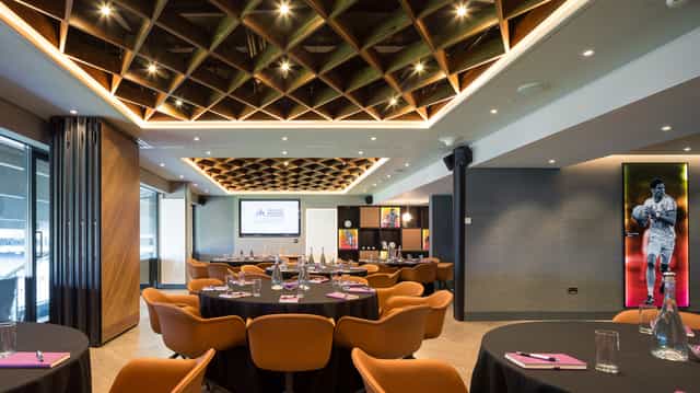 Modern meeting space at Croke Park with elegant round tables for corporate events.