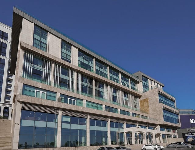 Modern Bayil Plaza business center with glass facade for corporate conferences and events.