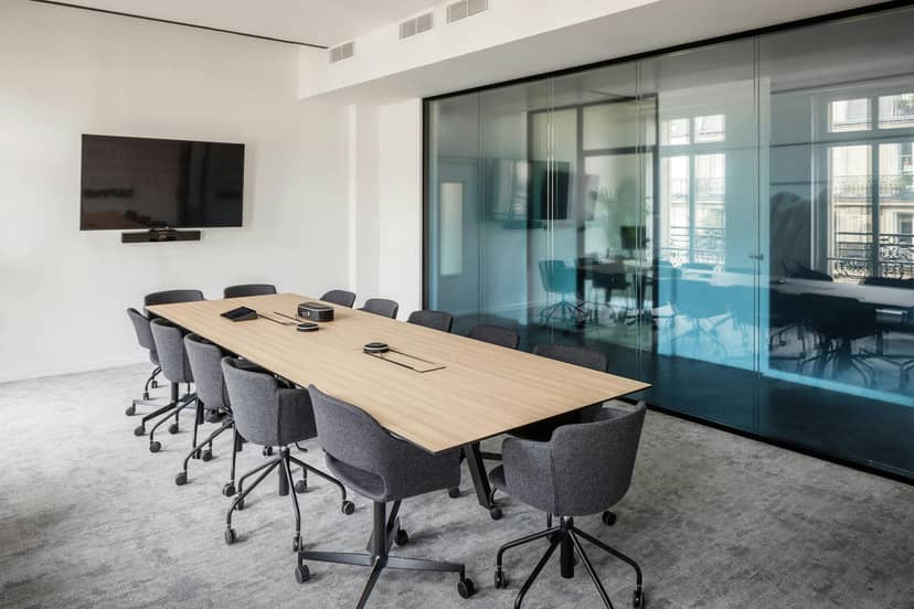Minimalist boardroom with A/V tech for hybrid meetings and professional corporate events.