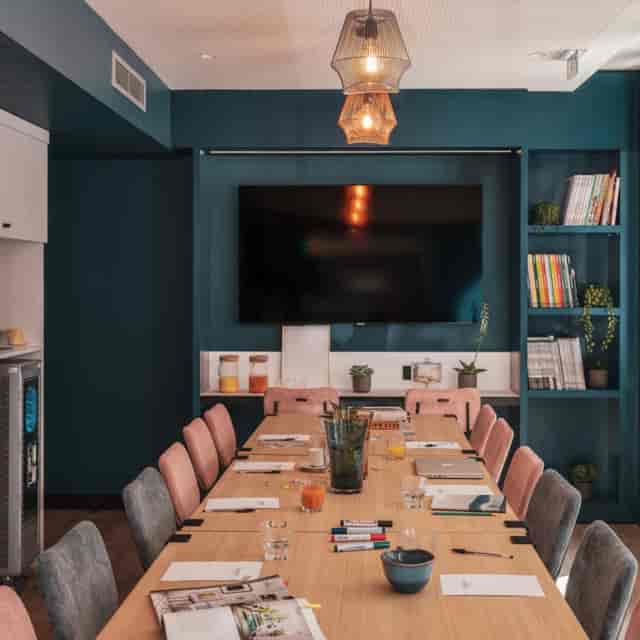 Boutique boardroom with ambient lighting for strategy sessions and client meetings.