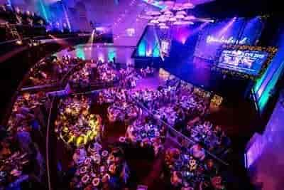 Vibrant Athena Space event with elegantly set tables and floral centerpieces for networking.