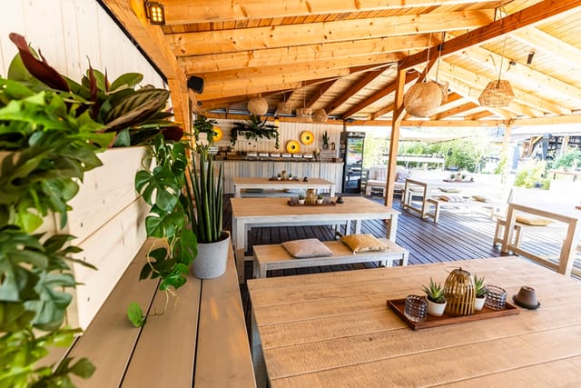 Kahuna Lounge open-air pavilion with rustic benches for corporate mixers and breakout sessions.