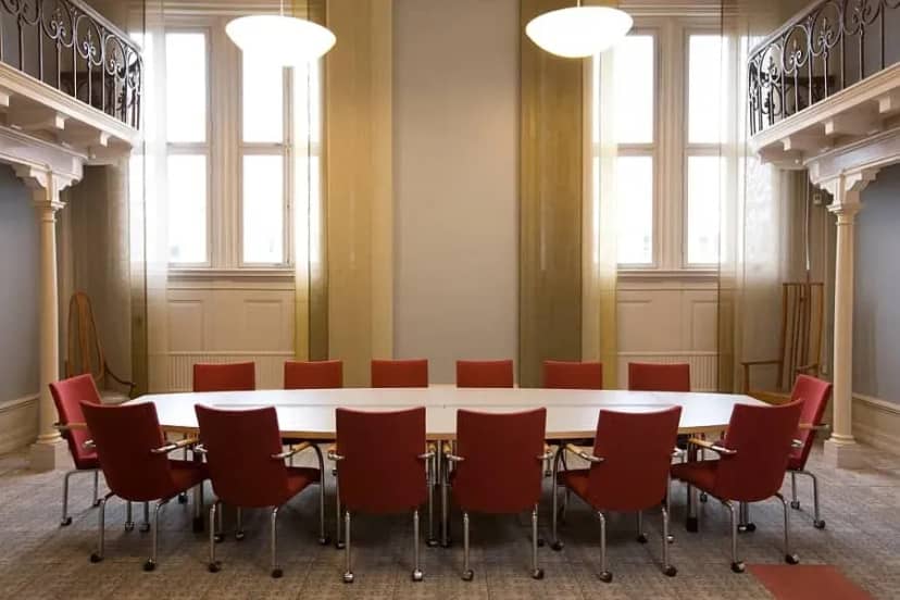 Modern boardroom in Bond Auditorium with natural light for executive meetings and conferences.