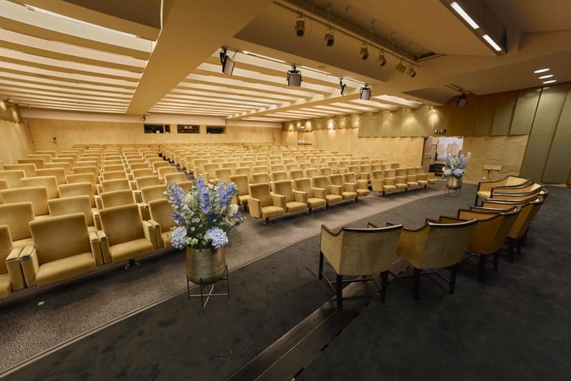 Bond Auditorium formal panel discussion stage with theater seating for keynote events.