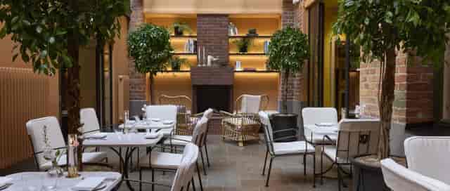 Upscale Garden breakout room at Hotel Villa Dagmar with brick fireplace for corporate events.