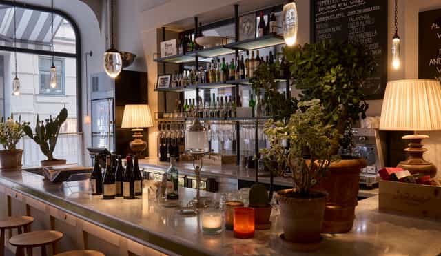 Hotel Villa Dagmar bar, warm ambient lighting, upscale networking event, VIP reception space.