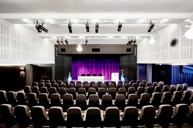 Piazzan auditorium in Stockholm with purple stage for corporate keynotes and professional events.
