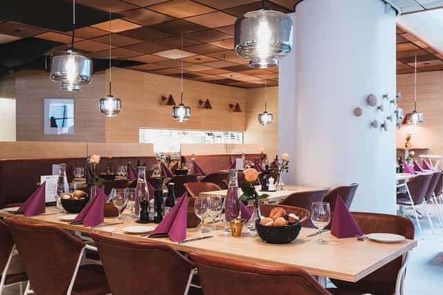 Upscale World Trade Center Stockholm luncheon venue with warm wood tones for corporate events.