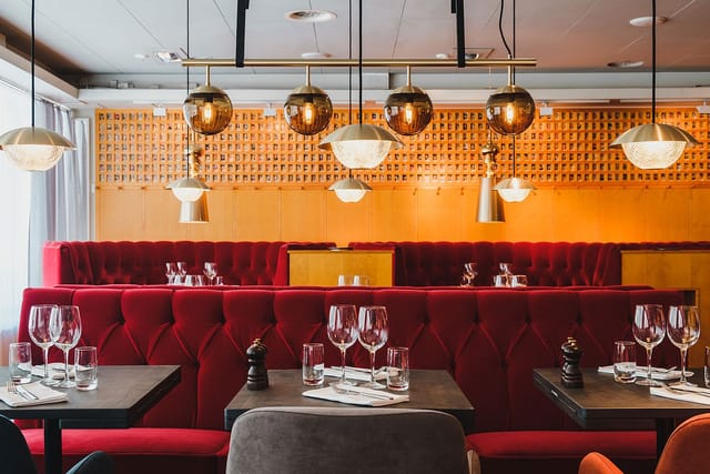 Salongen at Hotel Rival: Red velvet booth seating for VIP dinners and exclusive networking events.