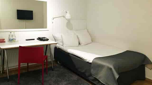 Budget-friendly Team Spirit conference hotel room, functional accommodation for business events.