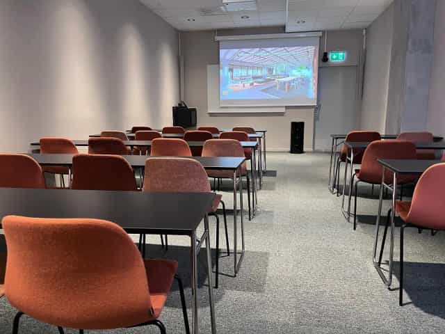 Classroom-style conference room for corporate training and educational workshops.