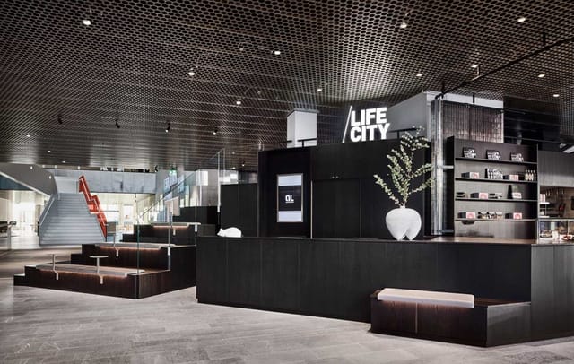 Modern Life City business park lobby with tiered seating for corporate events and networking.