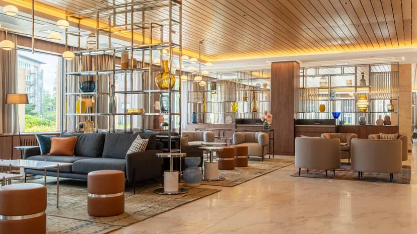 Modern hotel lobby in Trollskogen, Stockholm with versatile seating for corporate networking events.