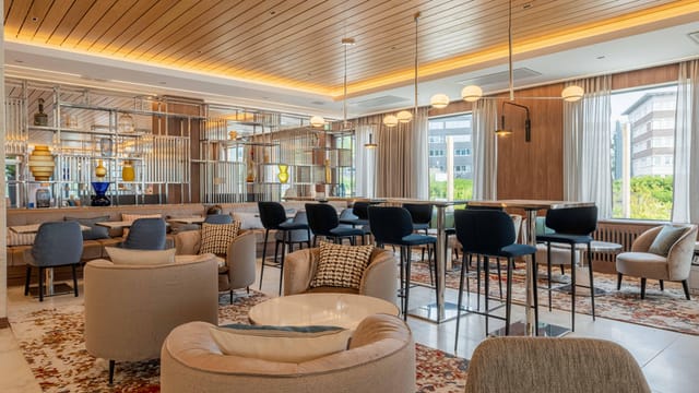 Voco Stockholm Kista breakout area with lounge seating for networking and corporate meetings.