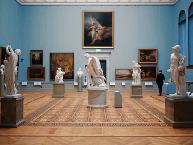 Sophisticated café gallery venue with statuary for high-end corporate receptions and events.