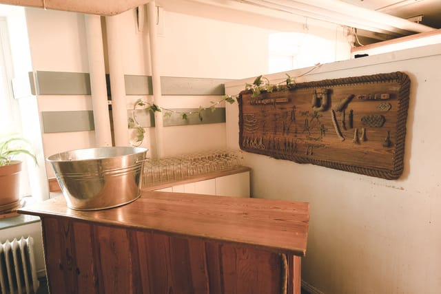 Rustic self-service beverage station in Segelsalen banquet hall for wedding catering.