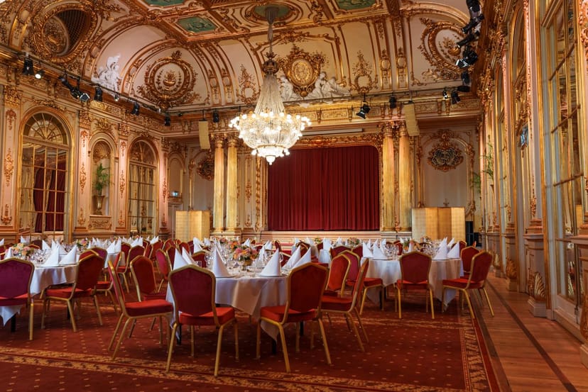 Elegant Segelsalen ballroom gala dinner with stage, historic architecture, and banquet seating.