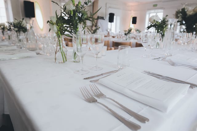 Minimalist banquet hall tablescape for high-end wedding and gala event venue.