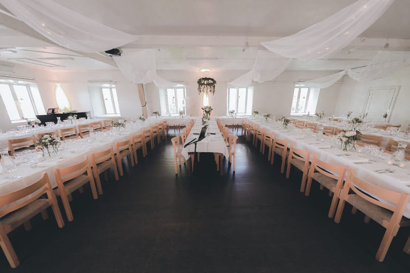 U-shaped banquet setup in Sailing Hall with elegant ceiling draping for events and conferences.