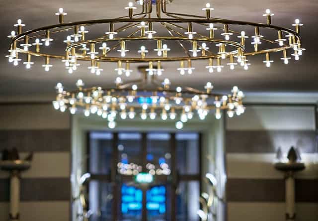 Stora Foajéen at Konserthuset featuring multi-tiered ring chandeliers for upscale event hosting.