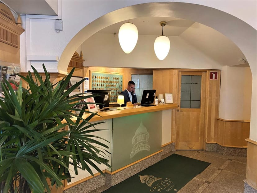 Restaurang Ming hotel front desk with classic woodwork for intimate event registration.