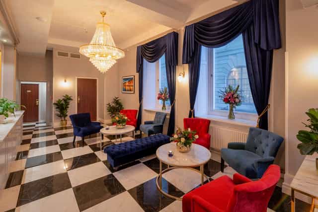 Hotel Gamla Stan lounge with crystal chandelier, ideal for luxury networking and corporate events.