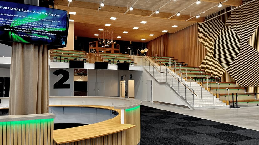 Modern Scandinavian XPO auditorium with tiered seating for tech conferences and workshops.