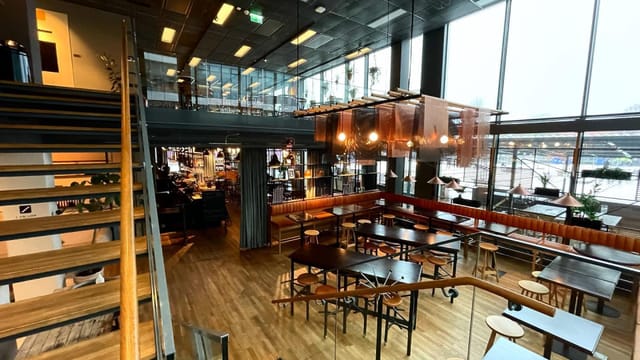 Industrial-chic Haga Bottega event space with floor-to-ceiling windows for corporate gatherings.