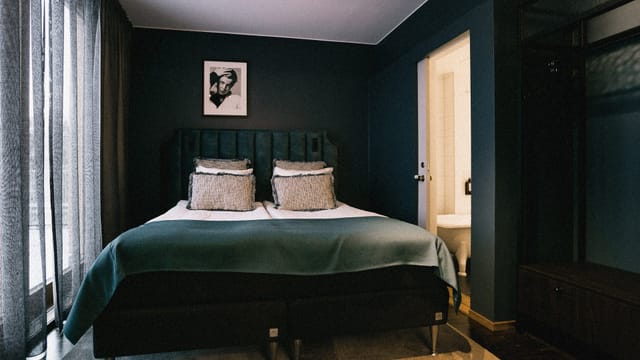 Upscale Backstage Hotel suite with mood lighting for executive travel and VIP event lodging.