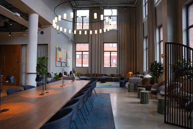 Modern meeting room with chandelier, ideal for collaborative workshops and upscale networking.