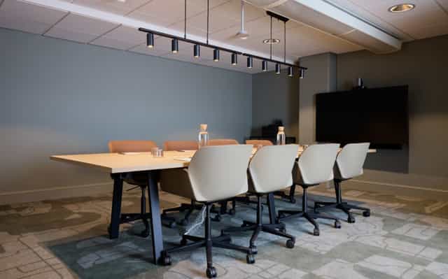 Modern boardroom at Clarion Hotel Tapetfabriken with six-person setup for business meetings.