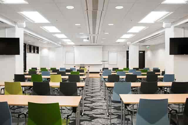 Classroom-style conference center with modern AV for corporate training and educational seminars.