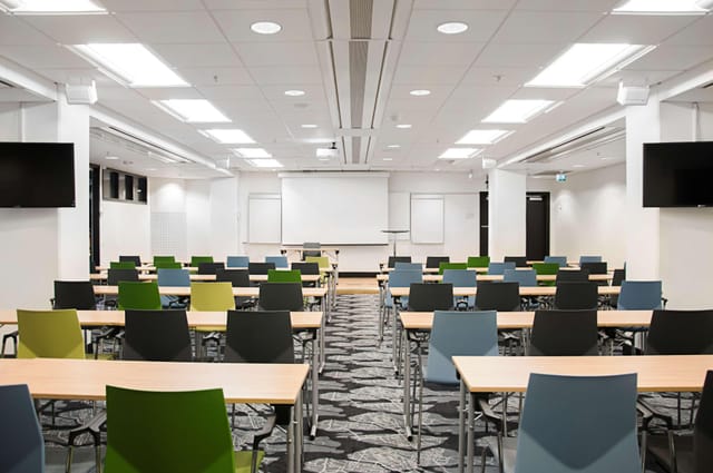 Classroom-style conference center with modern AV for corporate training and educational seminars.