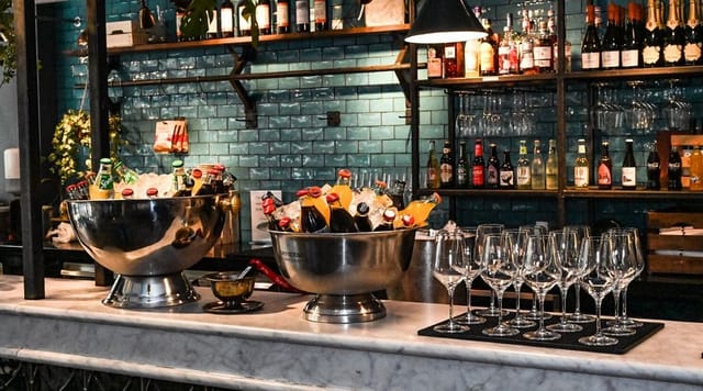 Self-service cocktail bar with ice buckets and glassware for corporate event catering.