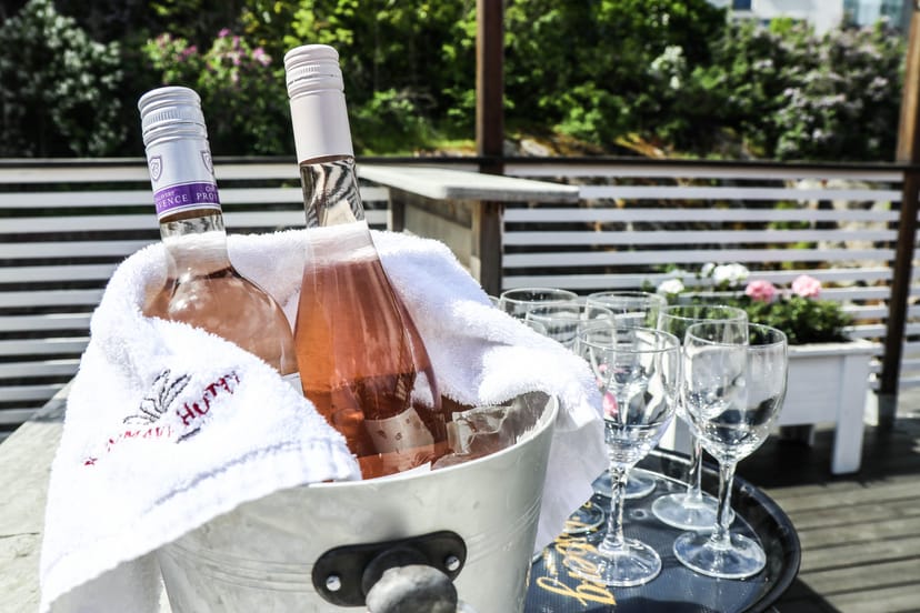 Outdoor networking reception at Brommavik Hotel with branded linens and rosé for corporate events.