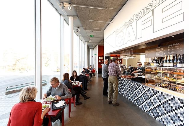 Bright cafe at Bonniers Konsthall with floor-to-ceiling windows for conference catering.